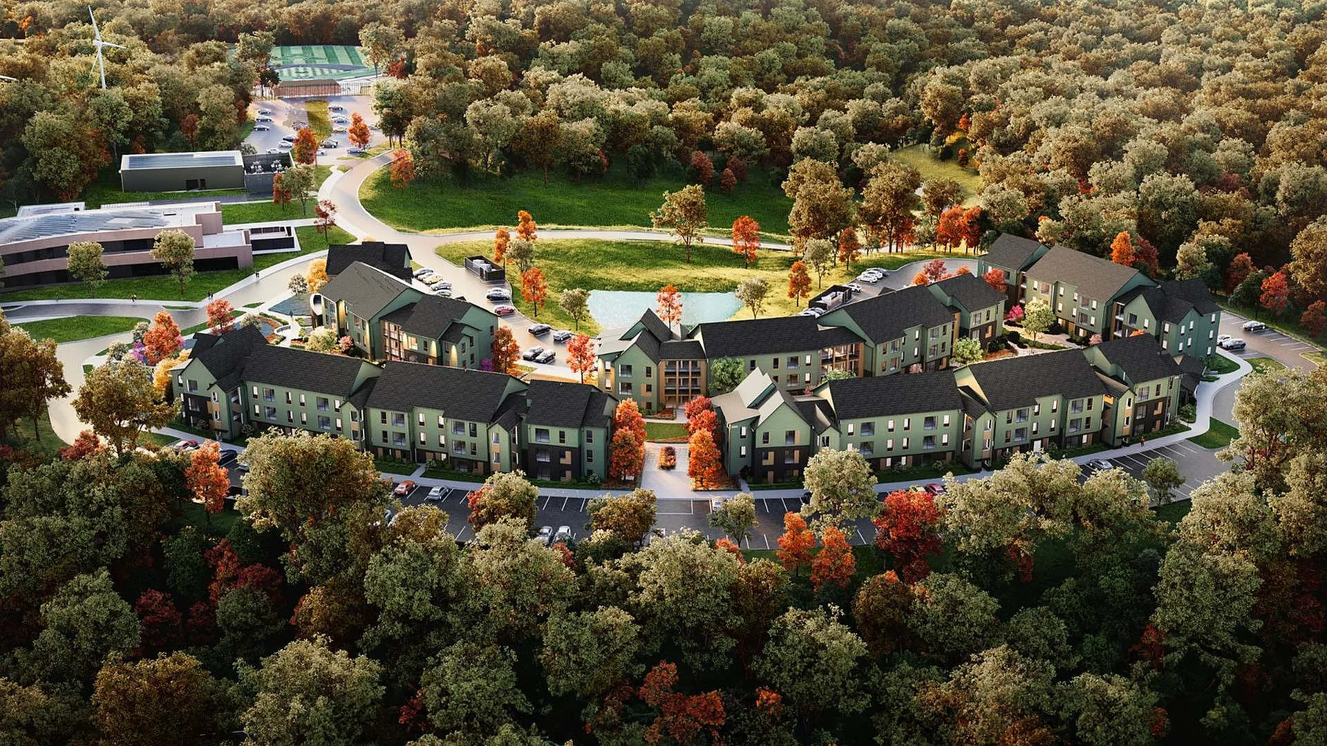 Aerial view of residential complex surrounded by trees.